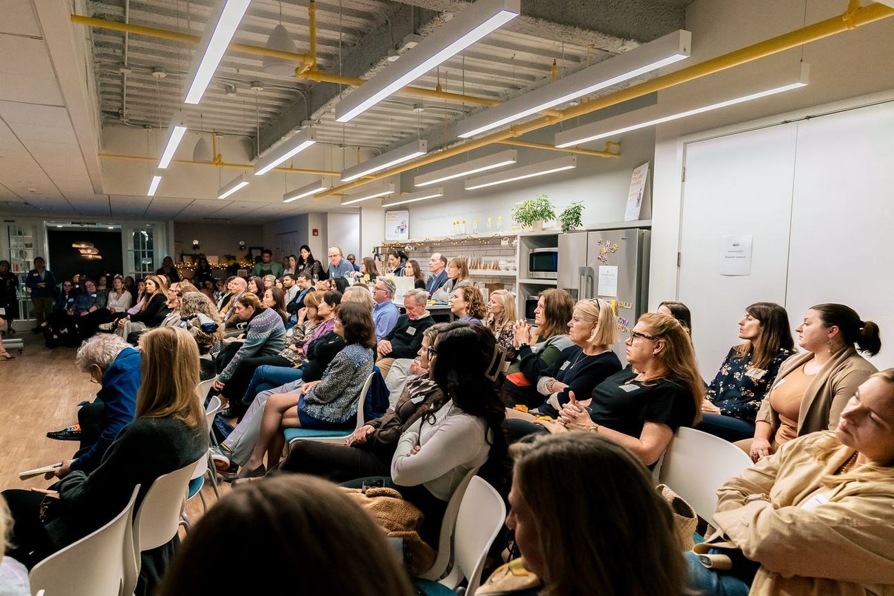 A full room of guests seated for HAYVN HATCH, the female founder pitch night, in the Darien event space