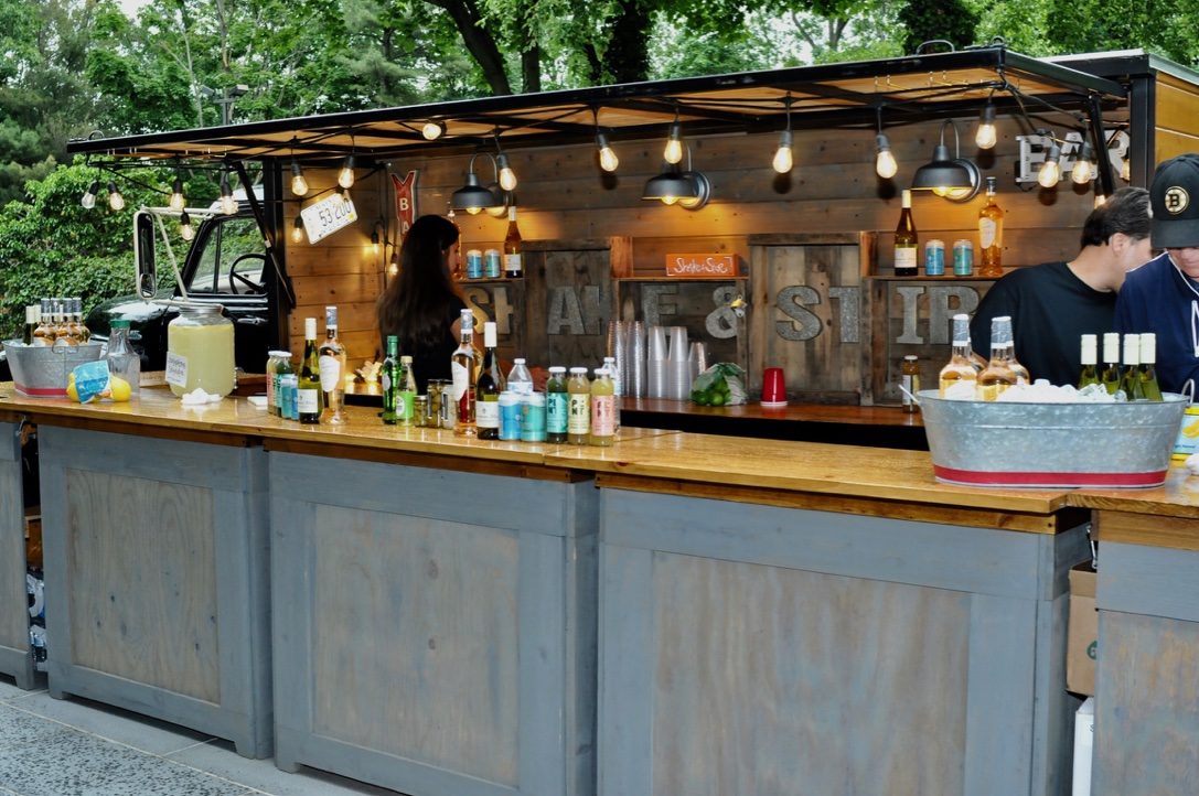 The reclaimed-timber Shake and Stir outdoor bar strung with festoon lighting at a HAYVN summer event